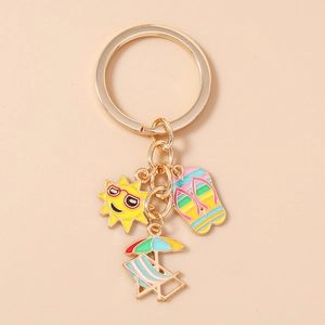 Detail of summer keychain with enamel sun, flip flops, and beach chair charms
