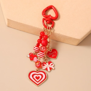Detail of beaded heart keychain with Marry Me engraving and colorful enamel pendants