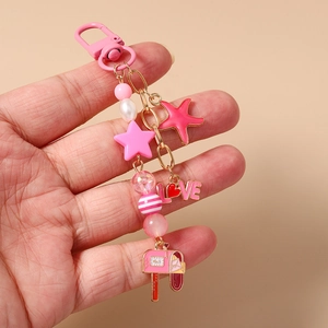 Detailed view of a pink beaded star and starfish keychain with LOVE letter charms