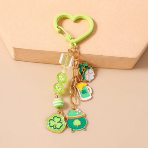 Detail of St. Patrick's Day keychain with green lucky clover charms and gnome pendant