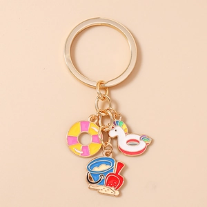 Detail of beach themed keychain with colorful unicorn float, lifebuoy and sand bucket charms