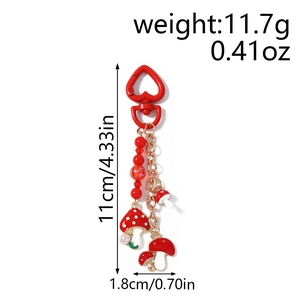 Détail du porte-clés champignon montrant les dimensions de 11 cm et le poids de 11,7 g