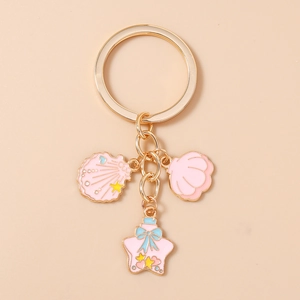 Detailed view of pink starfish and seashell charms on a gold beach-themed keychain