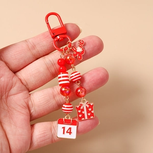 Detail of red Valentine keychain with Love plate, striped beads and February 14 calendar