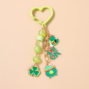 Detail of St. Patrick's Day keychain with clover charms and green beads on cream background