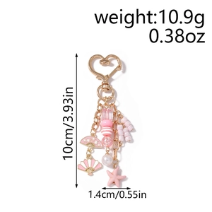 Detail view of starfish and fan charms keychain showing 10cm height and 10.9g weight