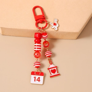 Detail of red Valentine beaded keychain with Love charm and February 14 calendar tag
