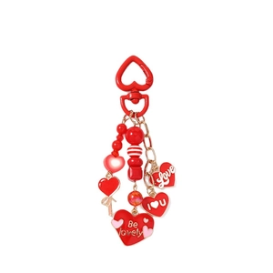 Red heart-shaped keychain with beaded letter charms and golden metal heart carabiner