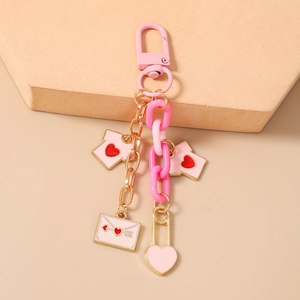 Detail of pink acrylic chain keychain with heart mini T-shirts and envelope pendants