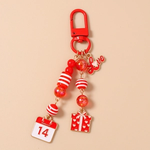 Detail of red beaded keychain with Love charm and February 14 calendar pendant