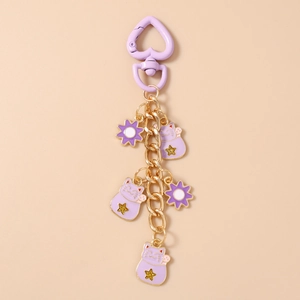 Close-up of purple Lucky Cat keychain with golden heart clasp and floral alloy charms