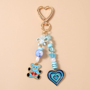 Blue beaded bear keychain with bow and star charms on a gold heart lobster clasp