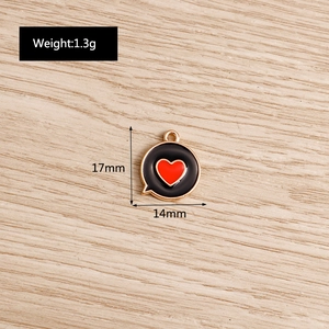 Detail view of heart pendant with 17mm x 14mm dimensions on wood texture surface