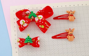 Detailed size view of Christmas bow hair clips and reindeer hairpins on a grid scale