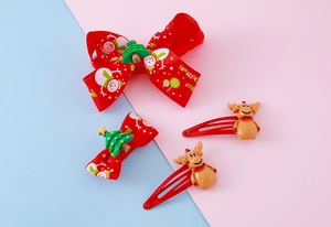 Detailed view of Christmas bow clips with snowman patterns and 3D reindeer hair pins