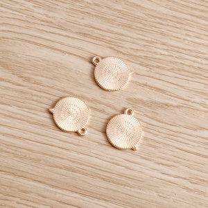 Three gold-plated heart sunburst charms with hanging loops for DIY jewelry making