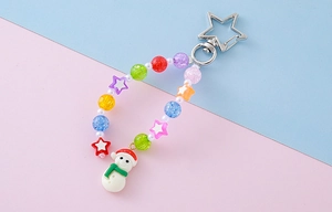 Close-up of beaded keychain featuring a snowman charm and colorful star-shaped beads