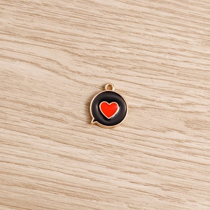 Detailed macro view of heart bubble enamel pendant with golden alloy frame for jewelry