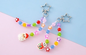 Detailed view of Christmas beaded keychains with Santa Claus and Snowman charms