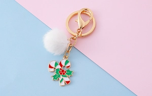 Vue détaillée du porte-clés canne de Noël avec pompon blanc et finitions dorées