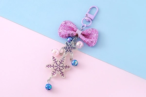 Detail of purple sequin bow and snowflake charm with colorful beads on a phone strap