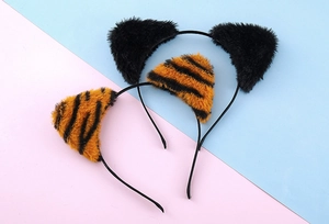 Detail view of plush black cat ears and striped tiger ear headbands for party costumes