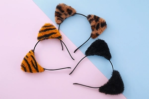 Detailed view of plush leopard and cat ear headbands in multiple styles and patterns