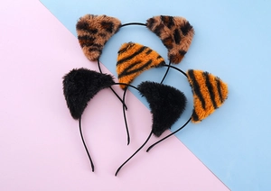 Detailed macro view of soft plush animal ear headbands in leopard and tiger patterns