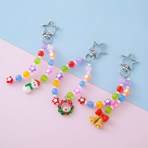 Colorful beaded Christmas keychains with snowman, wreath, and bell charms on star clips