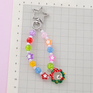 Handmade beaded keychain with a Christmas wreath snowman pendant and star-shaped metal clasp