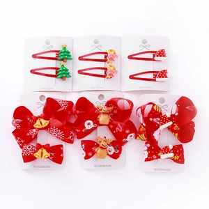 Christmas bow hair clips set with festive resin Santa and Reindeer motifs on white background