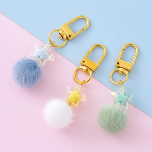 Star charm keychain set with soft faux fur pompom and colorful beads on macaron background