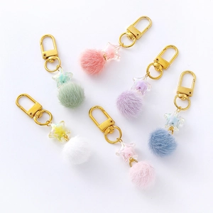 Set of 6 cute candy-colored star keychain pendants with fluffy pompons and golden clasps