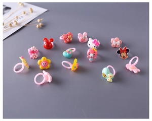 Nahaufnahme von Kinder-Cartoon-Ringen mit bunten Tier- und Blumenmotiven aus Harz
