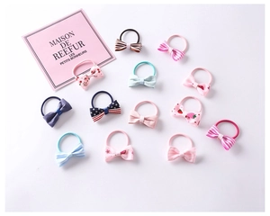Detailed set of 12 colorful fabric bow hair ties for children in various cute patterns