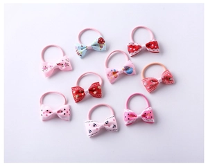 Detail of 9-piece colorful bow hair ties featuring patterns like polka dots and florals