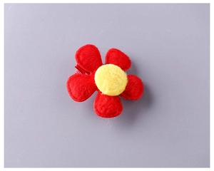 Detailed view of red felt flower hair clip with yellow center for children