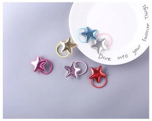 Detail of colorful star shaped hair ties featuring metallic finish and fine stitching