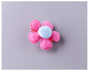 Detail of pink flower hair clip with soft plush petals and red metal duckbill clip