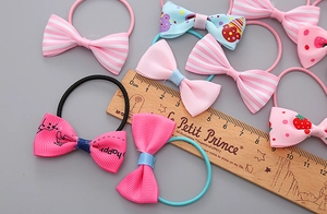 Detail showing 4cm width measurement of colorful bow hair ties with floral and striped patterns