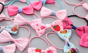 Detailed view of high-elastic kids hair ties with various ribbon bow patterns and colors
