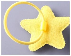Macro shot of the yellow star decoration and elastic band on a kids hair accessory