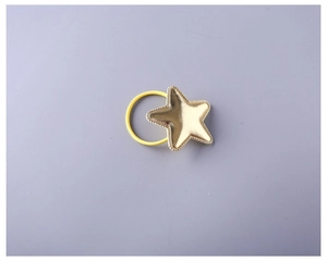 Close-up of a high-elasticity yellow hair tie with a golden star charm and beaded edge