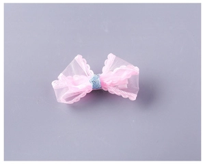 Detail view of the pink layered mesh bow hair clip with sparkling blue glitter center