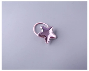 Detailed macro view of a metallic purple star ornament on a pink elastic hair tie band