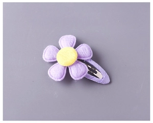 Detailed view of the purple fabric flower BB clip and ribbon wrapped metal hair pin