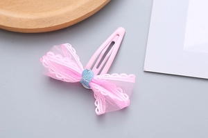 Detail of pink mesh bow hair clip for girls with blue sequins and pink metal snap clip