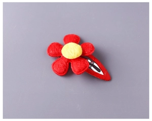Detail of red plush five-petal flower hair clip with yellow center for girls