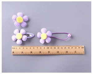 Detail view of purple flower hair clips with wood ruler showing the 4cm size dimensions