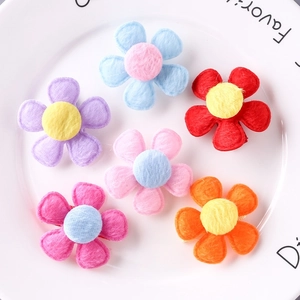 Set of 6 colorful felt flower hair clips for girls in a white ceramic plate